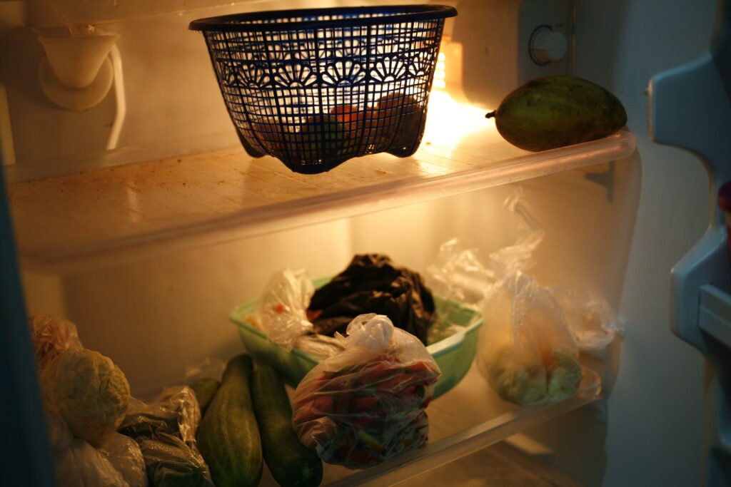 A photo of a refrigerator interior with groceries warming due to cooling failure